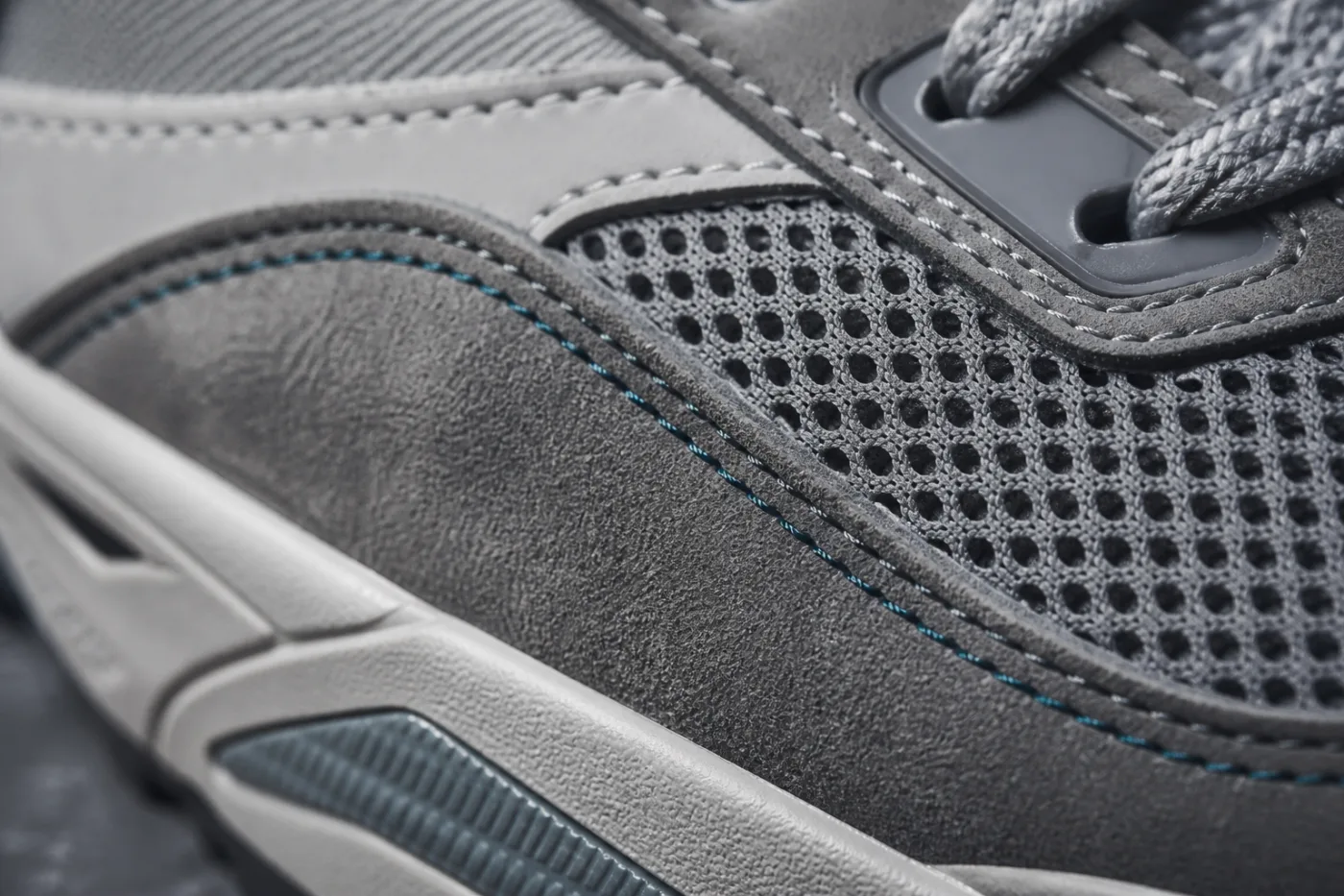 Macro detail of mesh upper stitched to a suede overlay