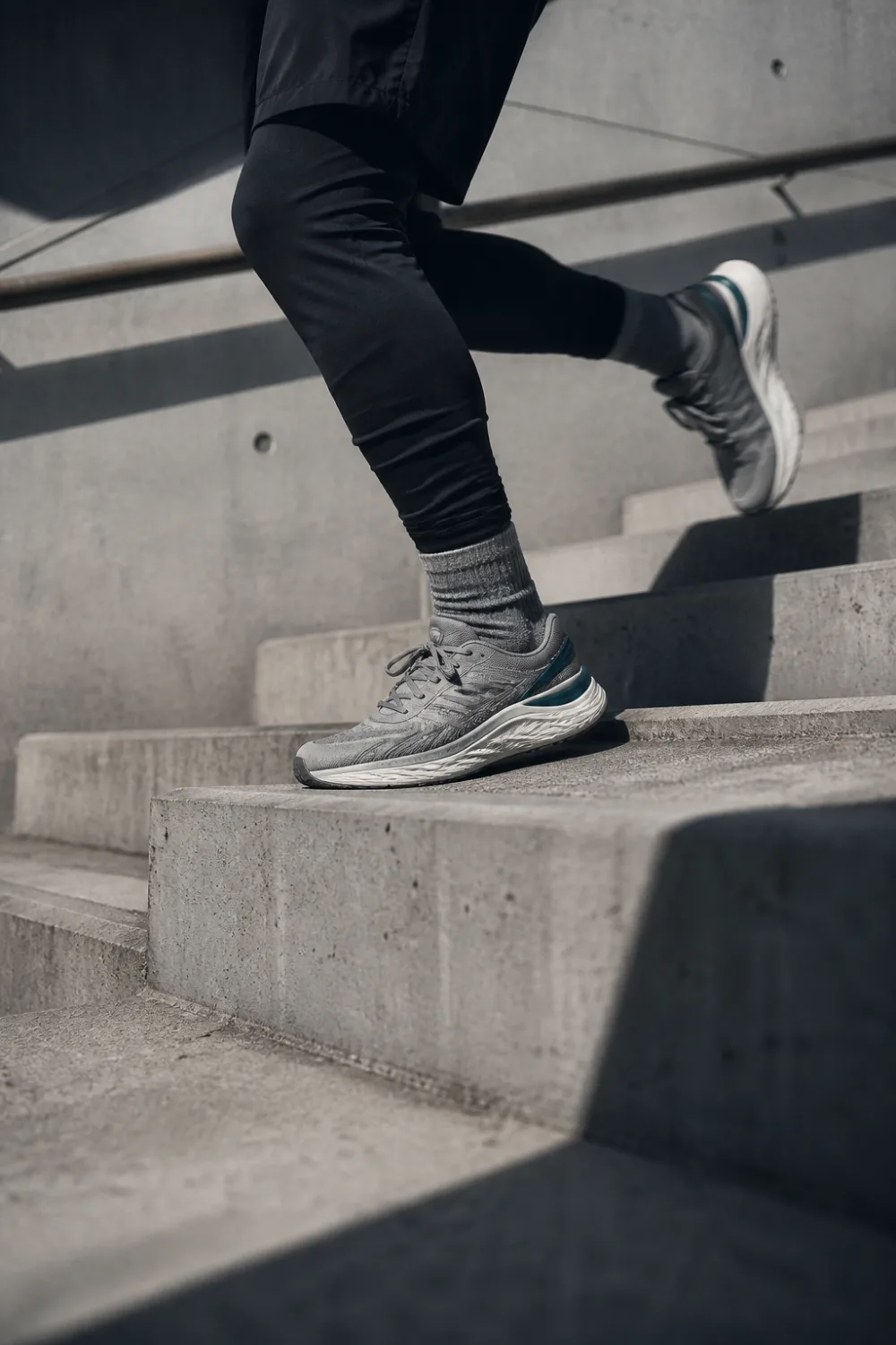 Runner mid-stride on concrete stairs
